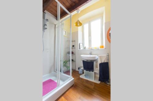 a bathroom with a glass shower and a sink at My Lovely Home in Cagliari
