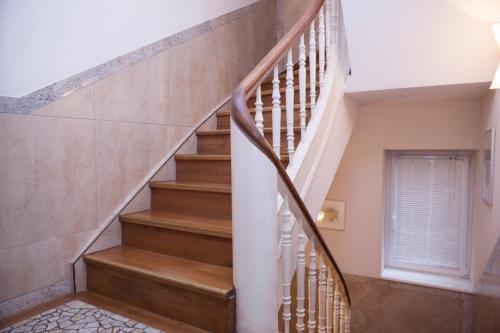 a winding staircase in a home with wood treads at Hotel Baden in Bonn