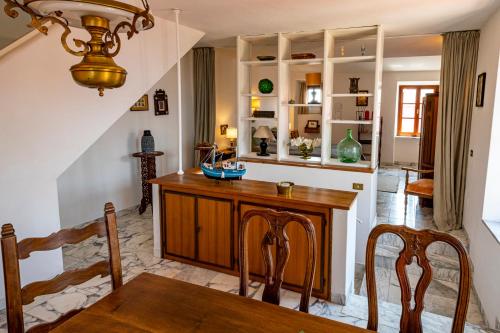 a kitchen with a wooden table and a dining room at Torre - Haus mit Dachterrasse in Capoliveri