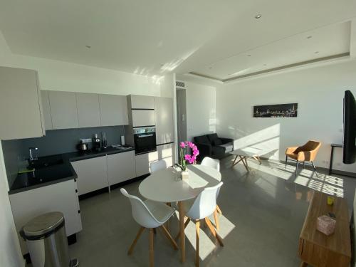 a kitchen and living room with a table and chairs at 219 Promenade in Nice