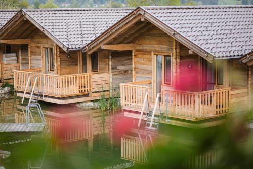 a log cabin on a body of water at Golf- und Sporthotel Moarhof in Walchsee