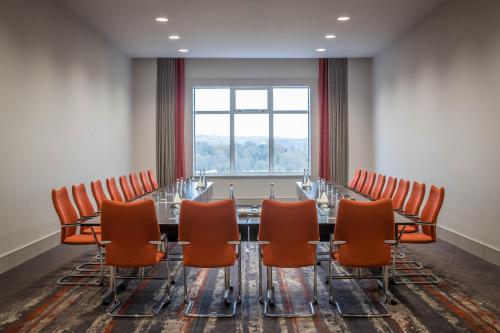 a conference room with a long table and chairs at Clayton Hotel Silver Springs in Cork
