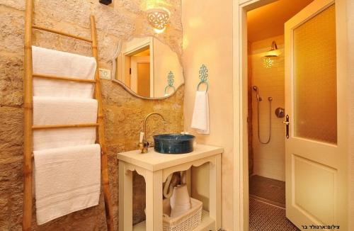 a bathroom with a sink and a mirror at THE MANSION in yesod hamaala in Yesod Hamaala
