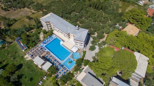 a large building with a blue sky at Koukounaria Hotel & Suites in Alykes