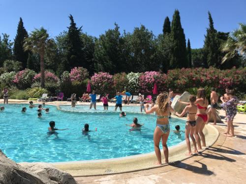 a group of people in a swimming pool at Camping Le Méditerranée Argelès - Domaine piétonnier in Argelès-sur-Mer