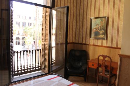 a room with a bed, chair and a window at Pensión Villanueva in Barcelona