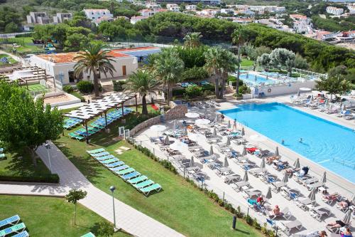 an aerial view of a resort with a swimming pool at Club Hotel Aguamarina in Arenal d'en Castell