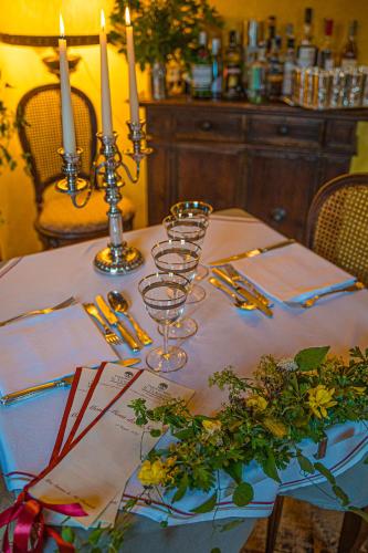 a table with candles and wine glasses on it at Villa Experience - Relais Il Termine Elba in Rio Marina