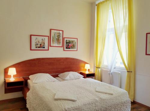 a bedroom with a large bed with two lamps at Apartment Amandment in Prague