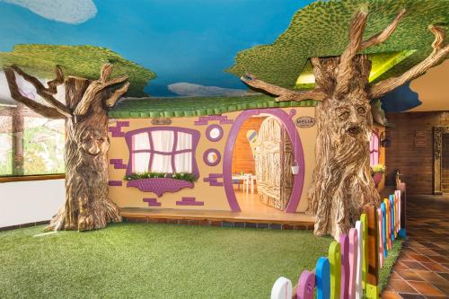 a play house with two trees and a fence at Melia Sierra Nevada in Sierra Nevada