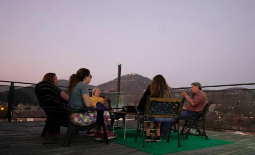 un grupo de personas sentadas en una mesa en un techo en Hotel Iris en Salta