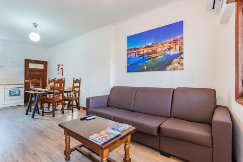 a living room with a couch and a table at Riverside City Centre Apartments in Porto