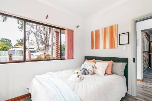 a bedroom with a bed and a large window at 1 Private Double Room In Berala 1 minute away from Train Station - ROOM ONLY in Regents Park