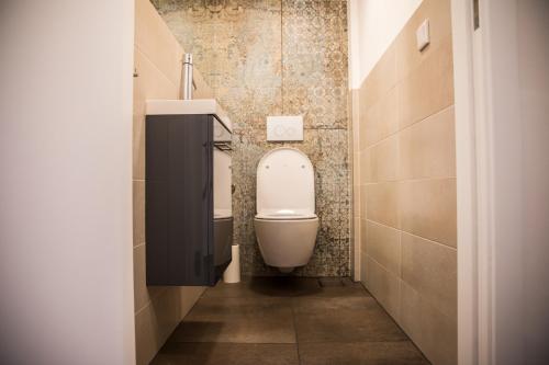 a bathroom with a toilet and a sink at Haus Lukic in Kaprun