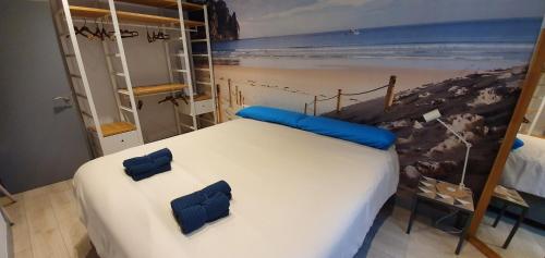 a bedroom with a bed and a painting of a beach at Skyline Bilbao in Bilbao