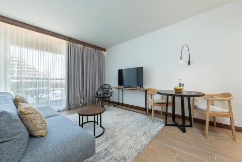 a living room with a couch and a table at Nevo by Isrotel Collection in Ein Bokek