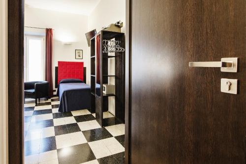 a room with a room with a bed and a door at Old Kitchen Vatican Suites in Rome