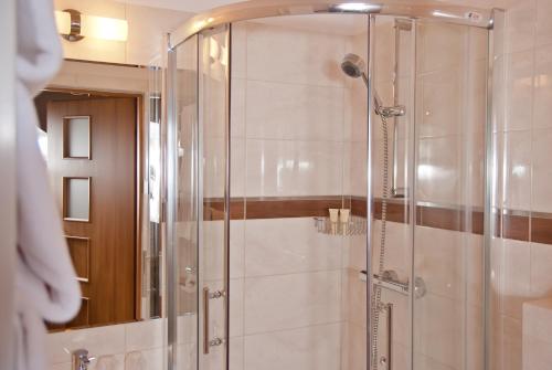 a shower with a glass door in a bathroom at Wielspin Puszczykowo in Puszczykowo