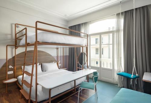 a bedroom with two bunk beds and a desk at Colors Urban Hotel Thessaloniki in Thessaloniki