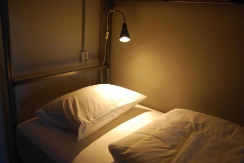 
A bed or beds in a room at Tehúsið Hostel
