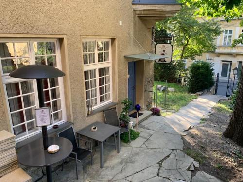 two tables and chairs outside of a building at Villa Pazelt Top1 in Bad Vöslau