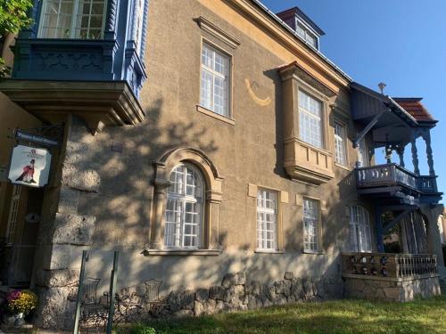a large brick building with windows and a balcony at Villa Pazelt Top1 in Bad Vöslau