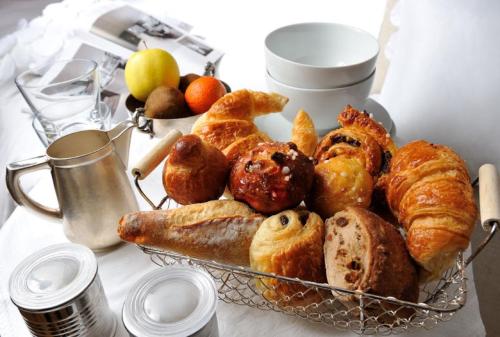 a basket of pastries and croissants on a table at Le Gourguillon in Lyon