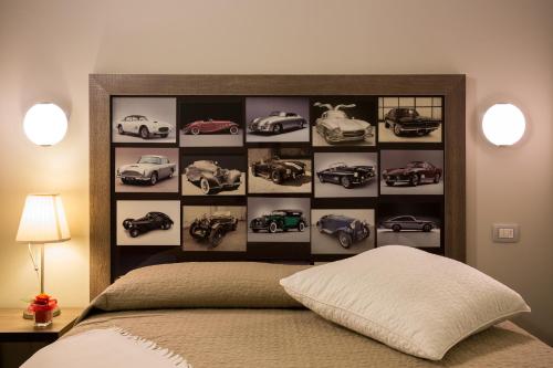a bedroom with a wall with cars on it at Locanda Borgognina in Lucrezia