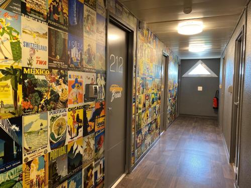 a hallway with posters on the walls at hotelF1 Laval in Changé