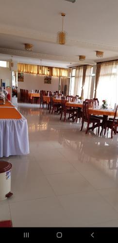 a dining room with tables and chairs in a restaurant at Bete Daniel Hotel in Bahir Dar