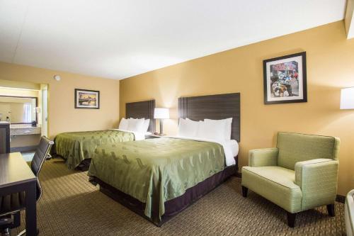 a hotel room with two beds and a chair at Quality Inn - White House in White House