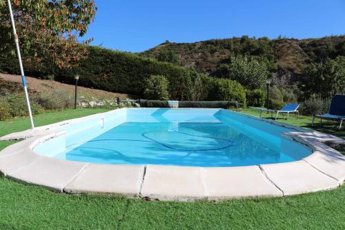 a swimming pool in the grass with at Casale Santilli in Agnone