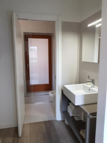 a bathroom with a sink and a toilet at Dimora diffusa Sannicolò al Fiume in Rovereto