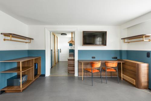 a living room with a table and two chairs at Colors Urban Hotel Thessaloniki in Thessaloniki