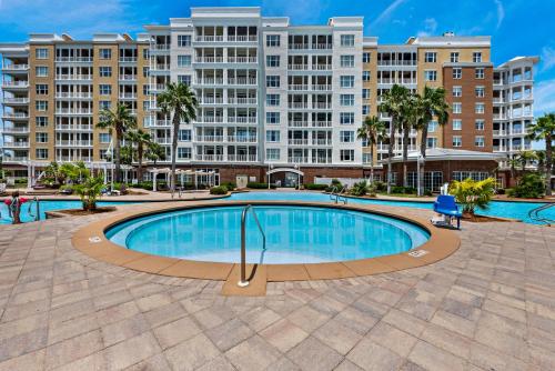 a large swimming pool with buildings in the background at Reflections at Bay Point in Panama City Beach