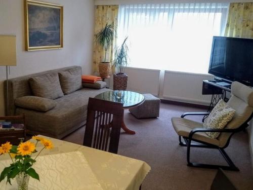 a living room with a couch and a table at Appartement Studio Kremser in Kranichfeld