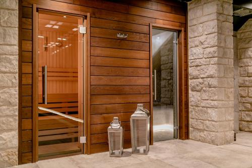a wooden door with two glass vases in front of it at Boutique Hotel & Spa Casa del Mare - Mediterraneo in Herceg-Novi