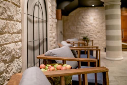 a row of wooden benches with apples on them at Boutique Hotel & Spa Casa del Mare - Mediterraneo in Herceg-Novi