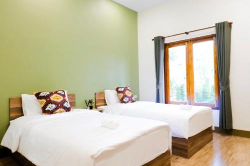 Postel nebo postele na pokoji v ubytování The Cozy Hotel