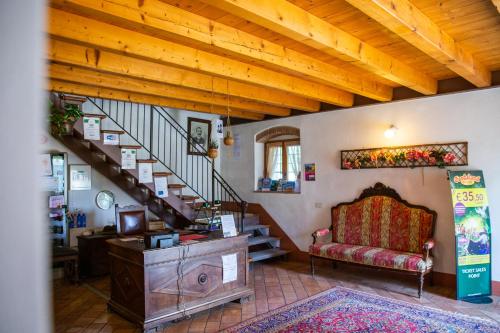 a living room with a staircase and a couch at Agriturismo Ca' Vecia in Castelnuovo del Garda