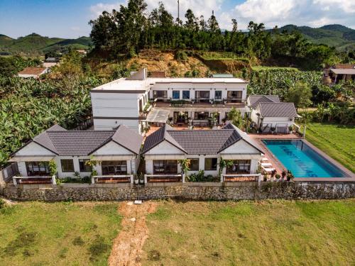 an aerial view of a house with a swimming pool at Karst Villas Phong Nha in Phong Nha