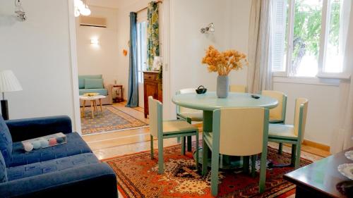 a living room with a table and chairs at Comfortable Apartment in Kallithea by Athenian Homes in Athens