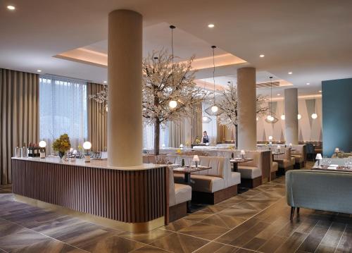 a restaurant with tables and chairs and a bar at Fairways Hotel Dundalk in Dundalk