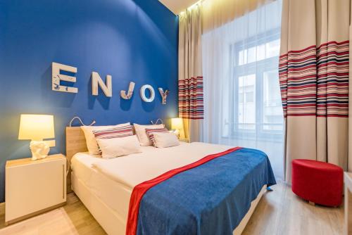 a bedroom with a bed with a blue wall at Estilo Fashion Hotel Budapest in Budapest