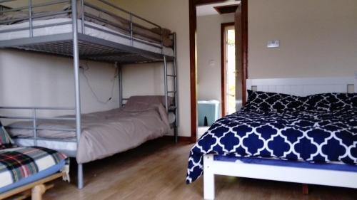 a bedroom with two bunk beds and a bed at Harbor View in Uig