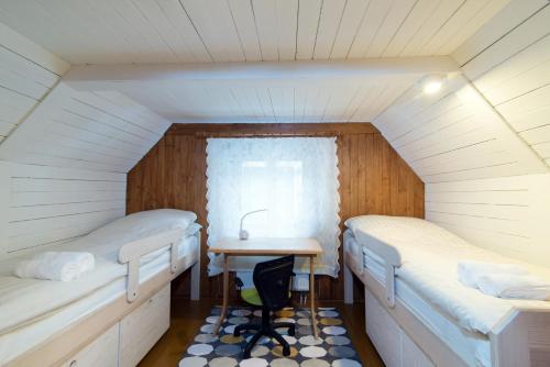 a room with two beds and a table in it at DOMEK NAD WISŁĄ in Kazimierz Dolny