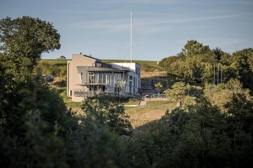 a house on top of a hill with trees at Boutiquehotel Genusswerk Eifel in Körperich