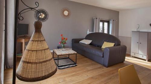 a living room with a couch and a table at Laniella location in Calvi