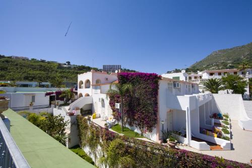 a view of a white house with ivy at Hotel Castiglione in Ischia