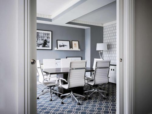 a dining room with a table and chairs at Sofitel Lafayette Square Washington DC in Washington